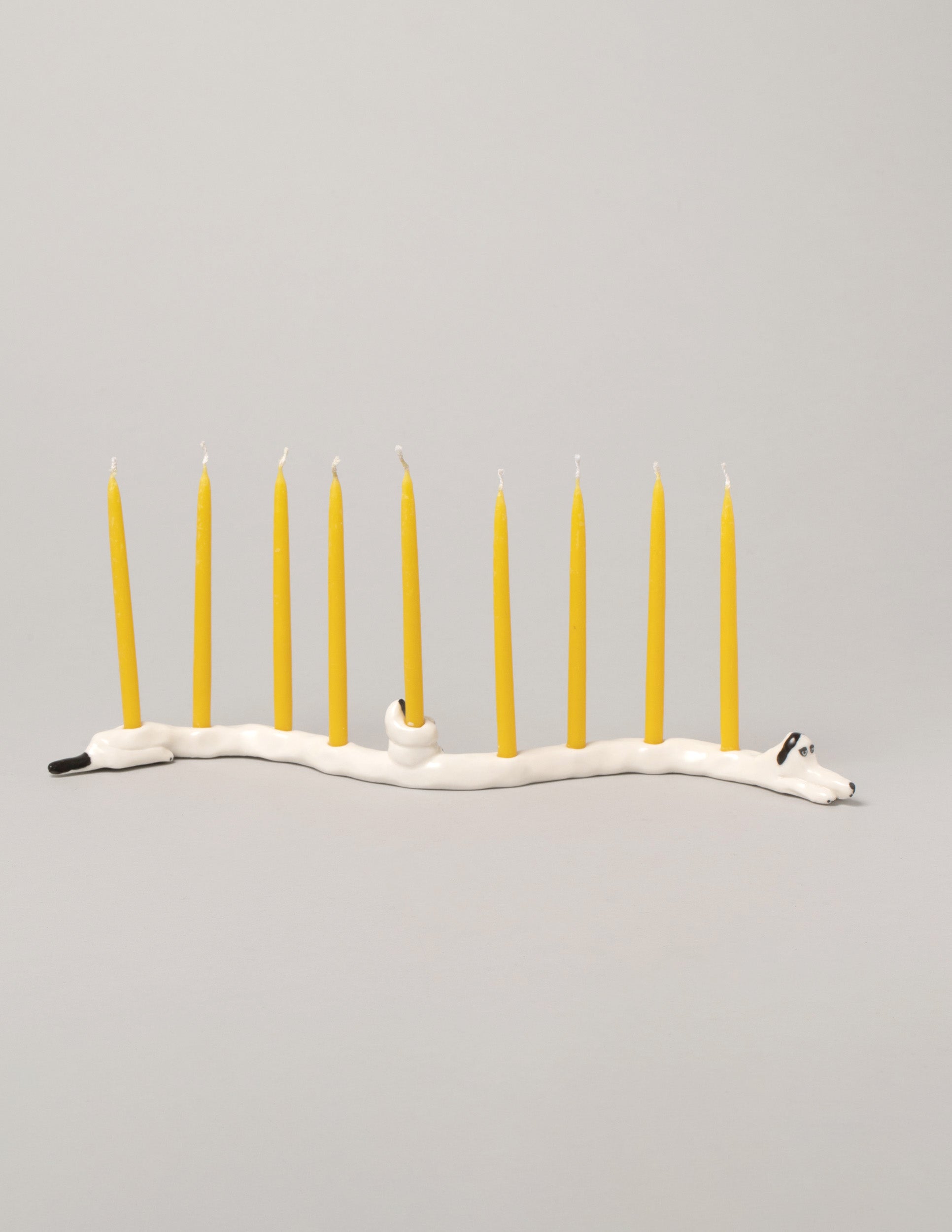 Detail view of the Eleonor Boström Black Ears Dog Menorah on light color background.