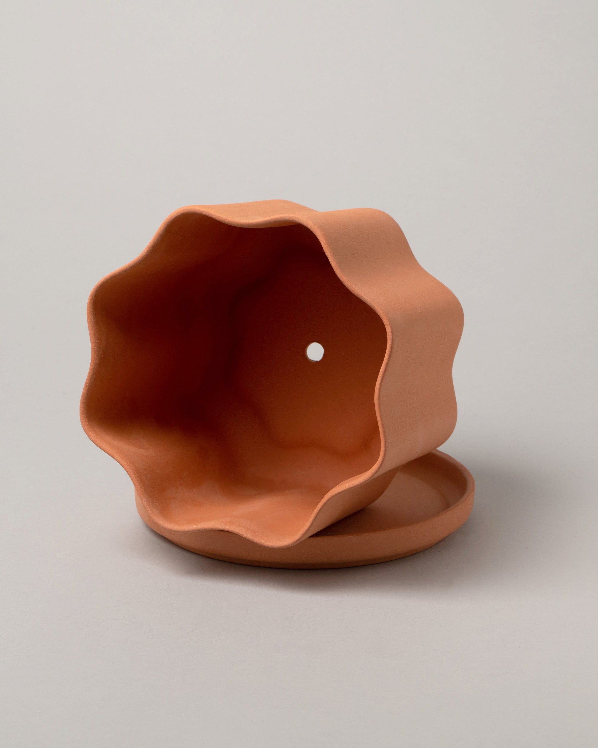 Inside view of the Peaches Terra Medium Wavy Planter on light color background.