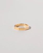 Closeup details of the Gold 4mm Segmented Half Hoop Band on light color background.