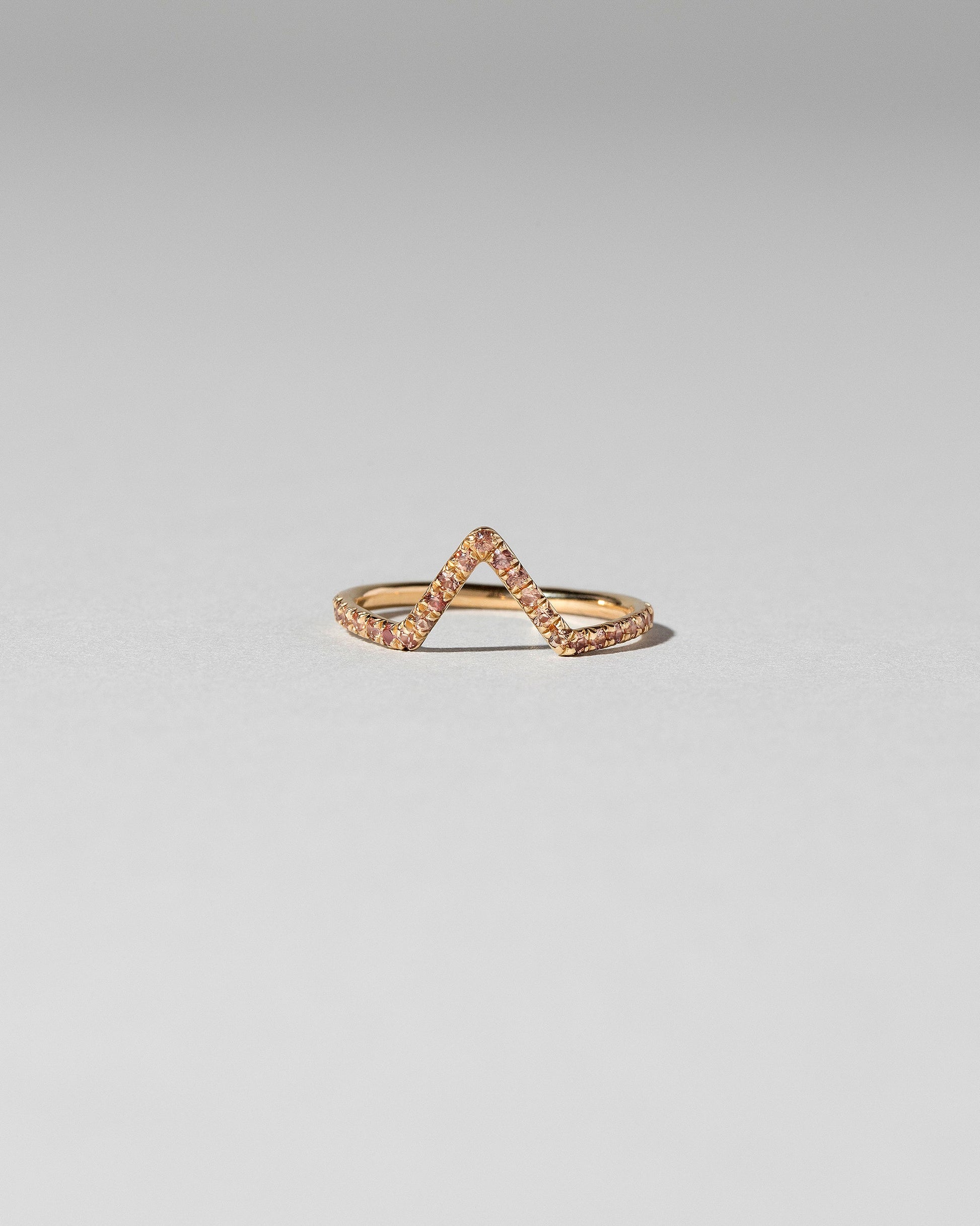 Peach Sapphire Pavé Triangle Band on light color background.