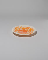 Stories of Italy Orange Nougat Dessert Plate on light color background.