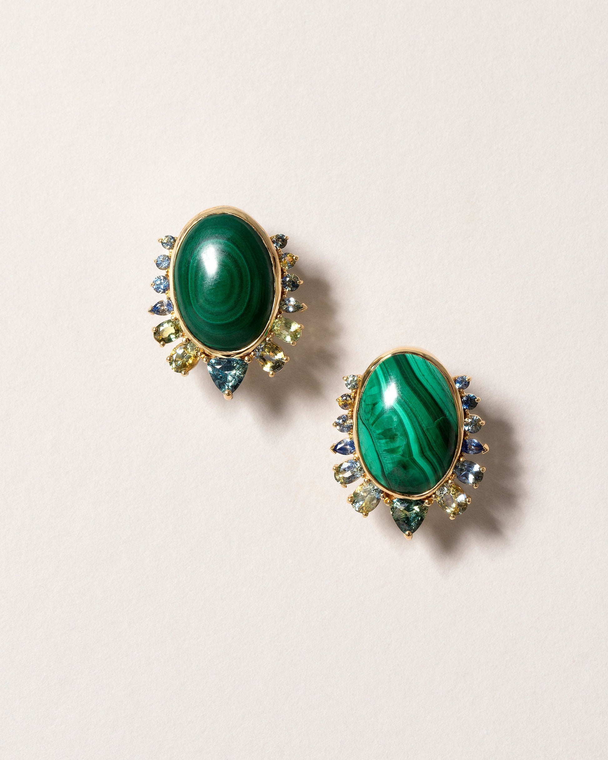 Malachite & Sapphire Earrings on light color background.