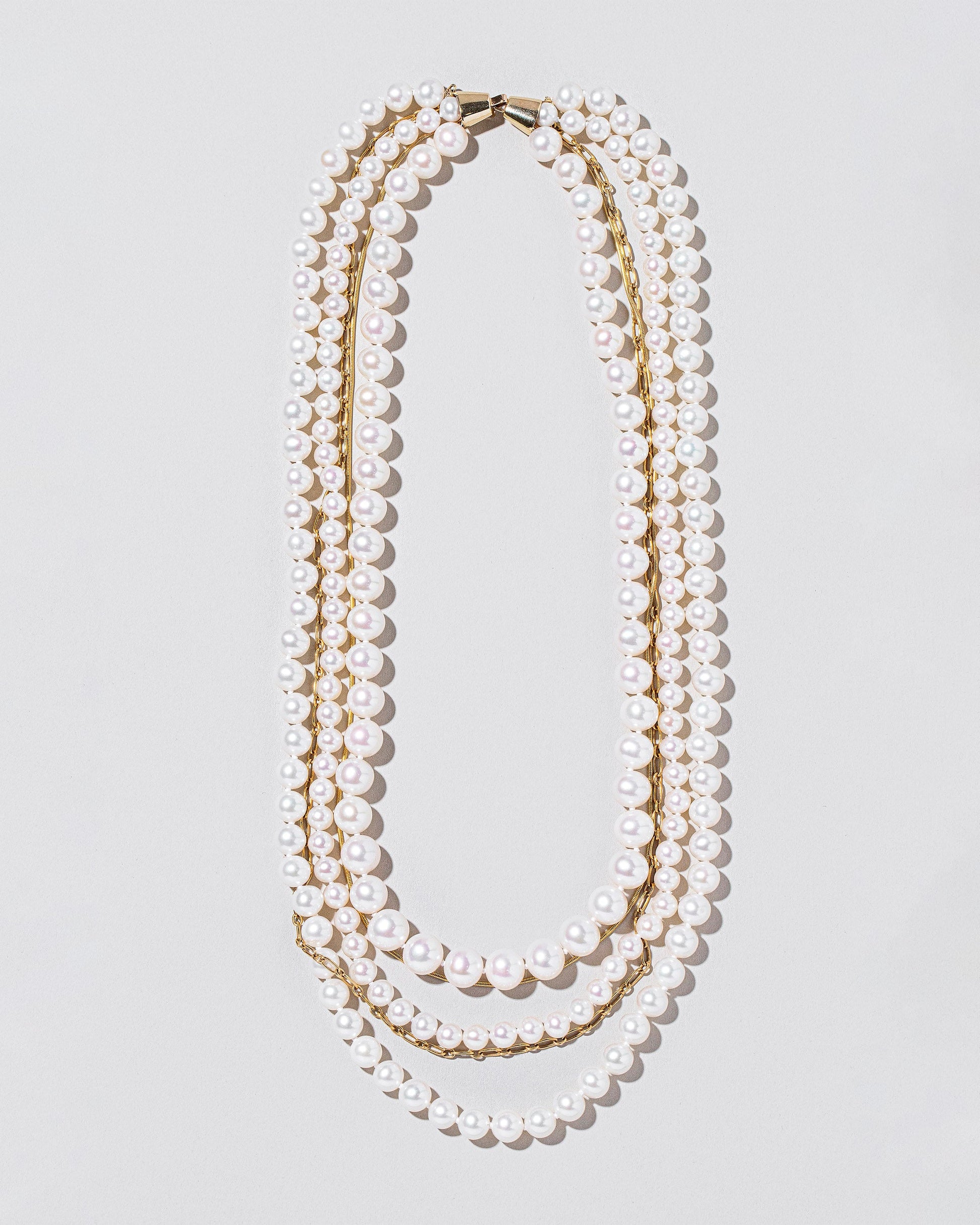 Layered Pearl Necklace on light color background.