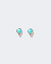 In-Between Earrings on light color background.