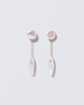 Triton Earrings on light color background.