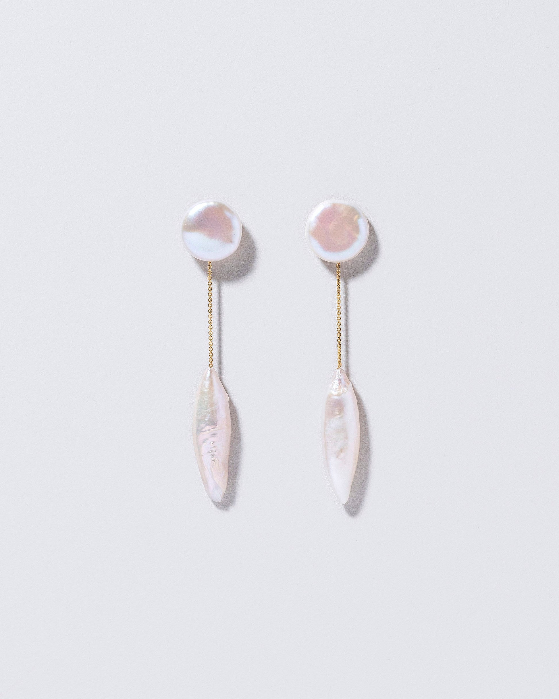 Triton Earrings on light color background.