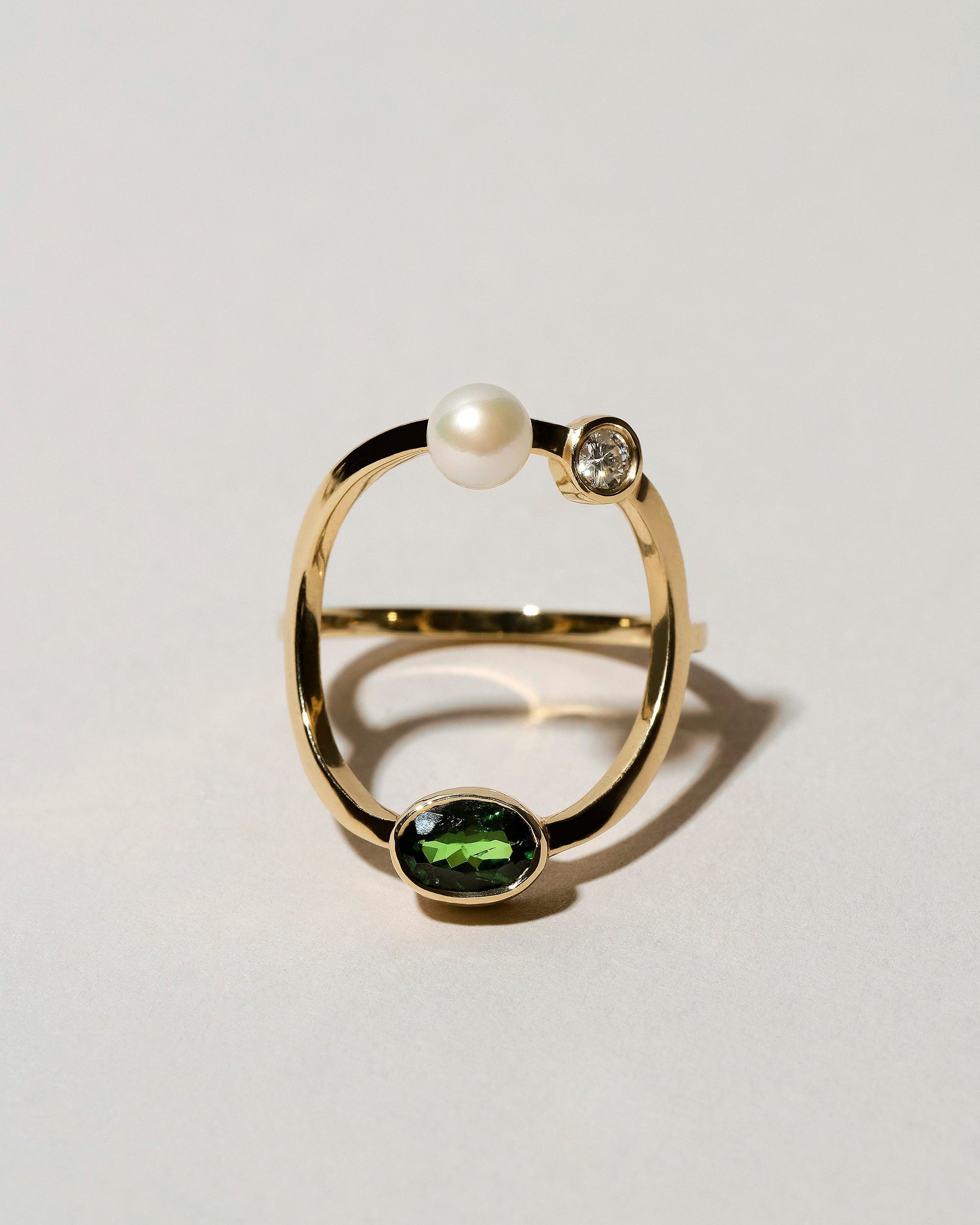 Trilogy Ring - Tsavorite on light color background.