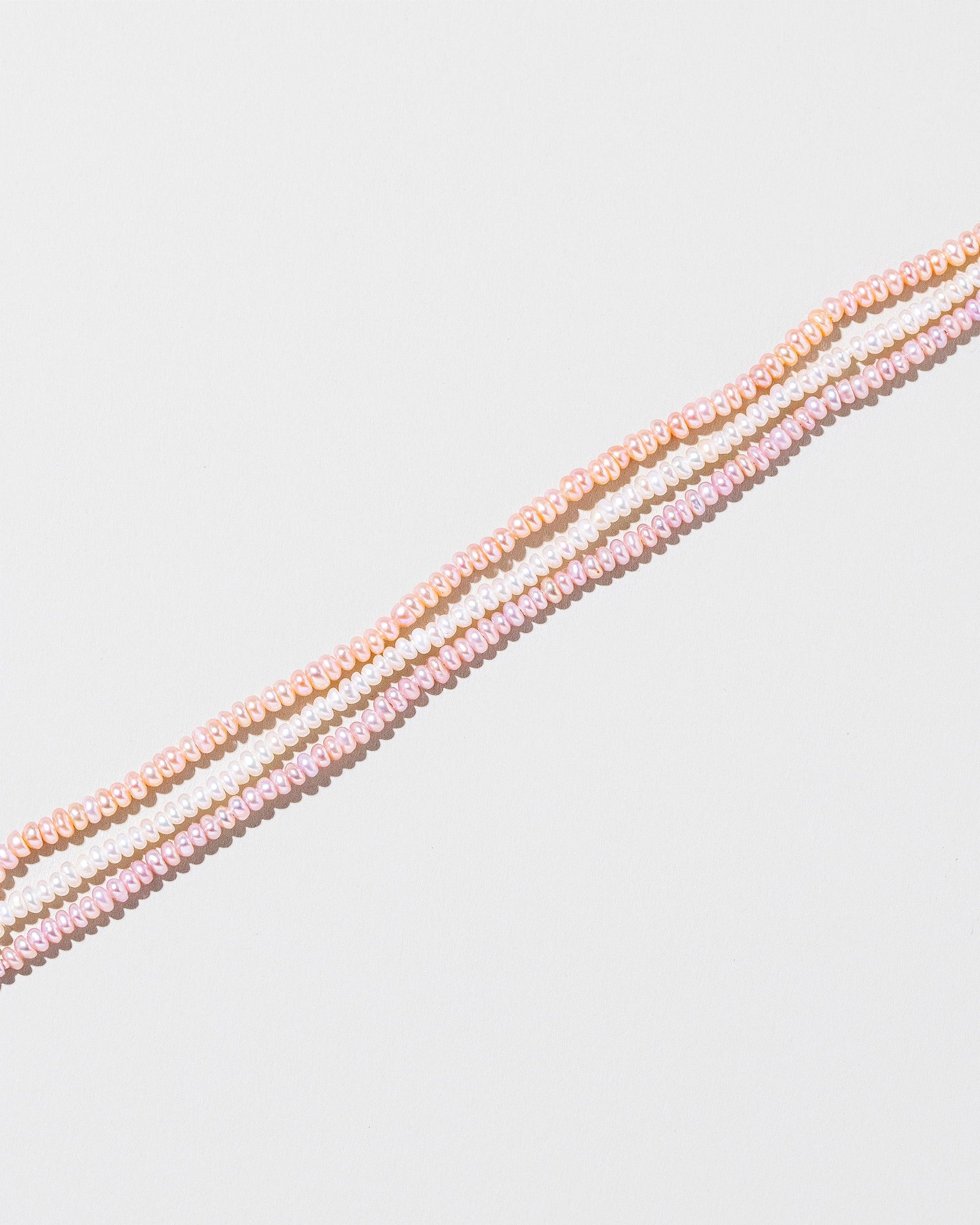 Multi Strand Seed Pearl Choker on light color background.