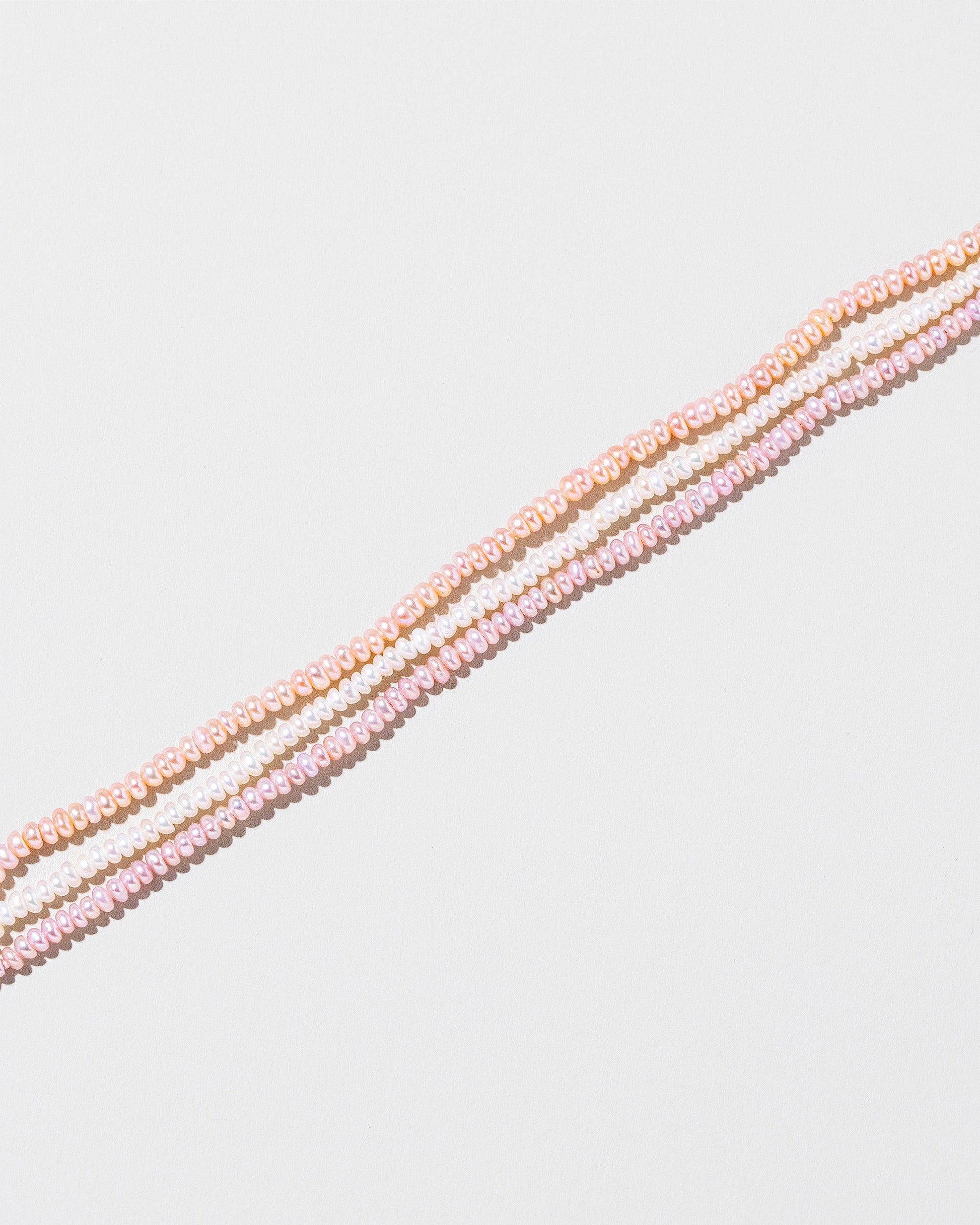  Multi Strand Seed Pearl Choker on light color background.