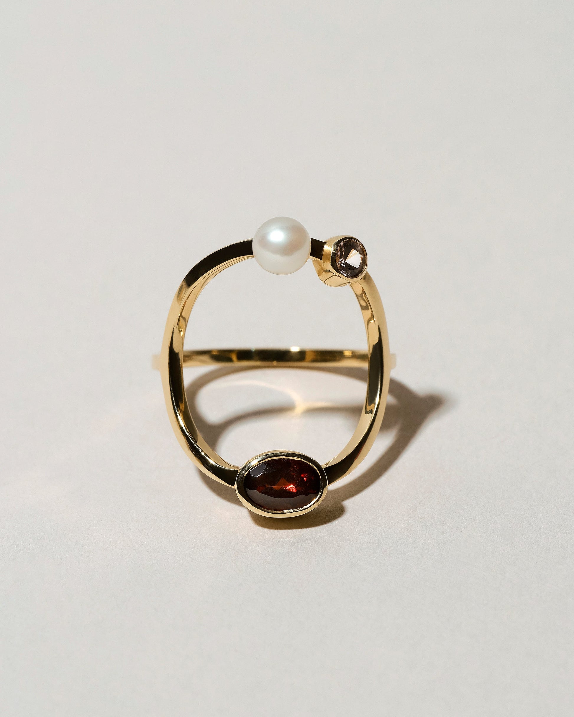 Trilogy Ring - Garnet on light color background.