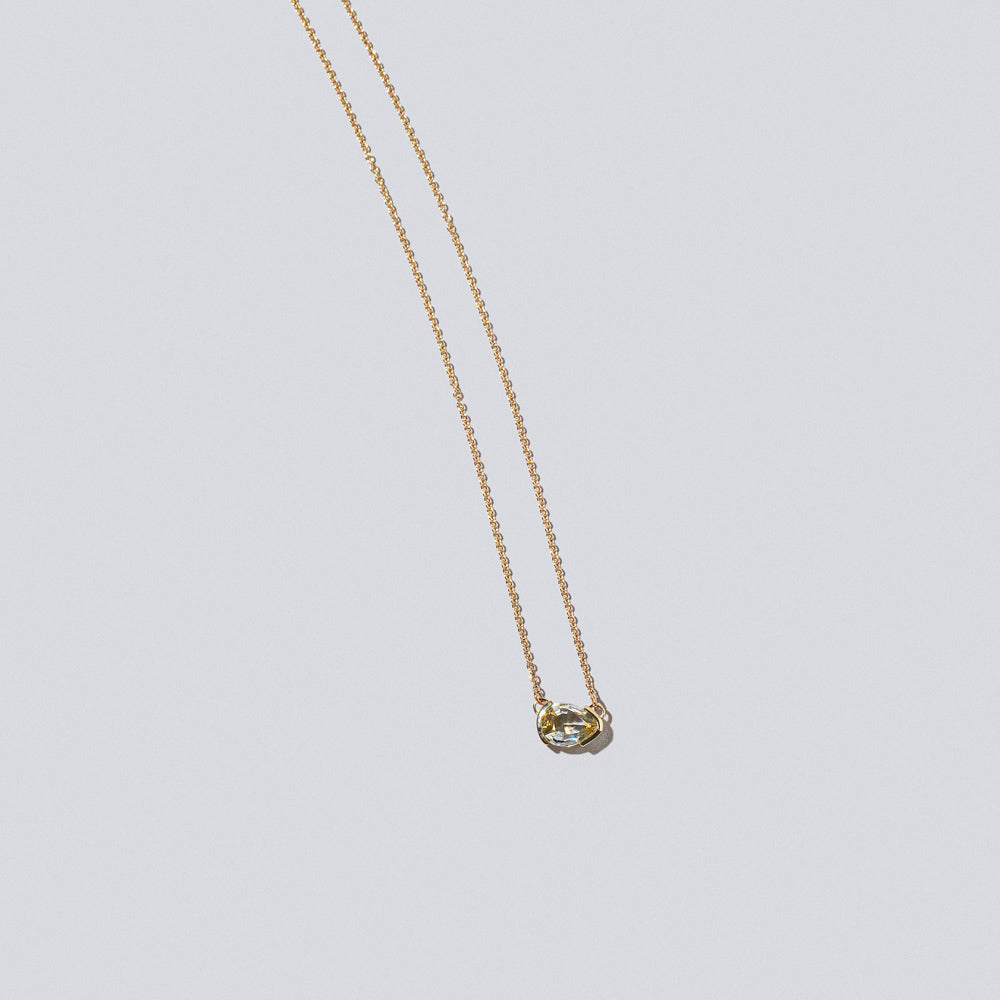 product_details::Closeup details of the Guppy Necklace on light color background.