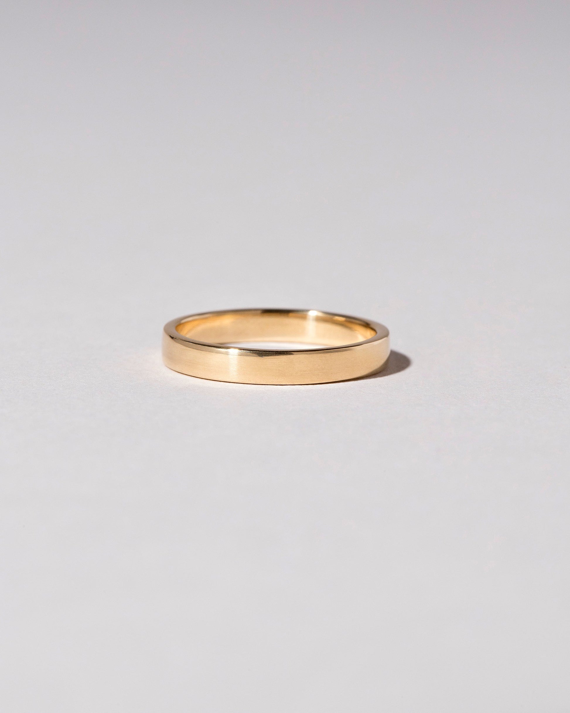 Gold 4mm Square Wire Band on light color background.