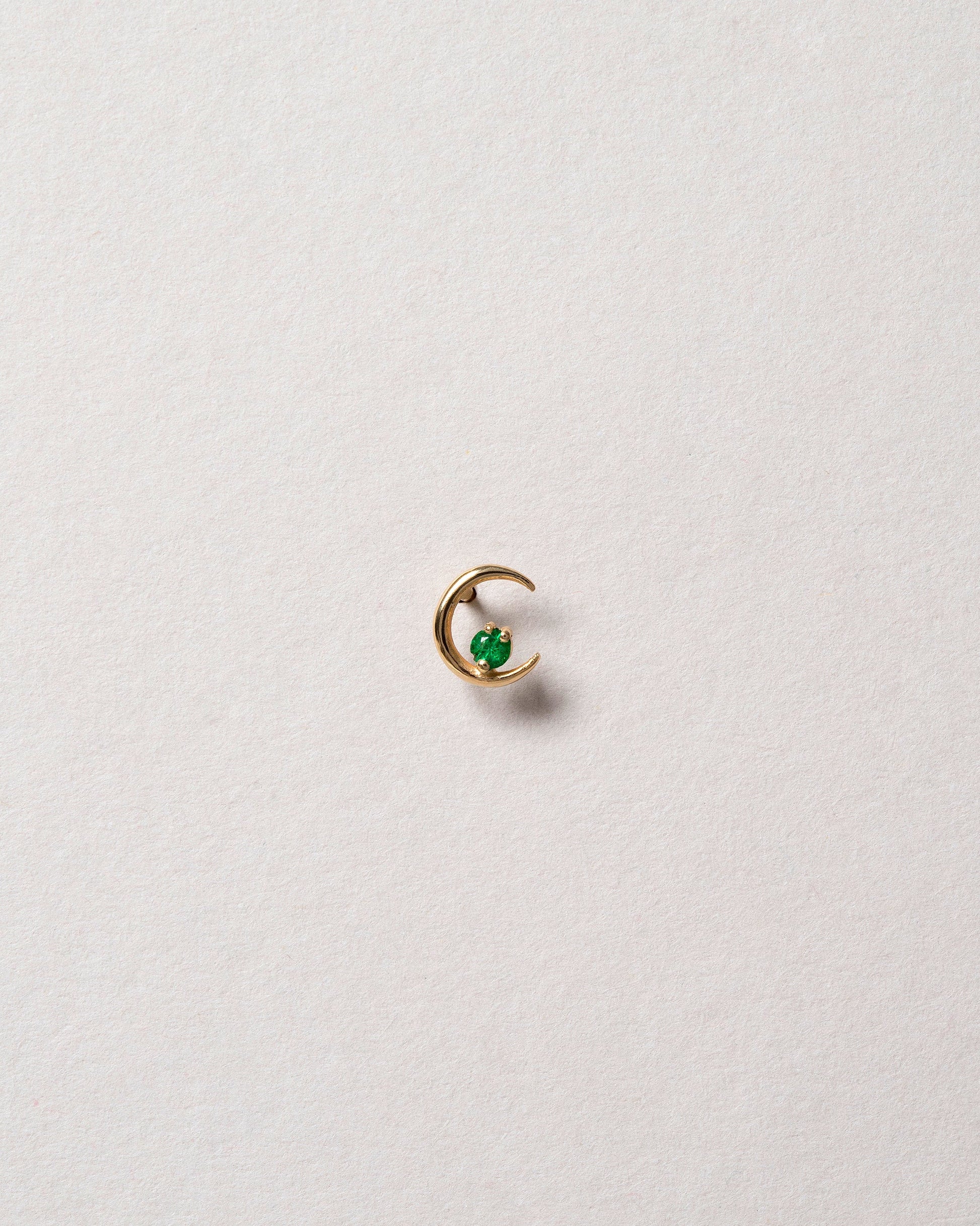 Right Emerald Moon Ray Stud Earring Single on light color background.
