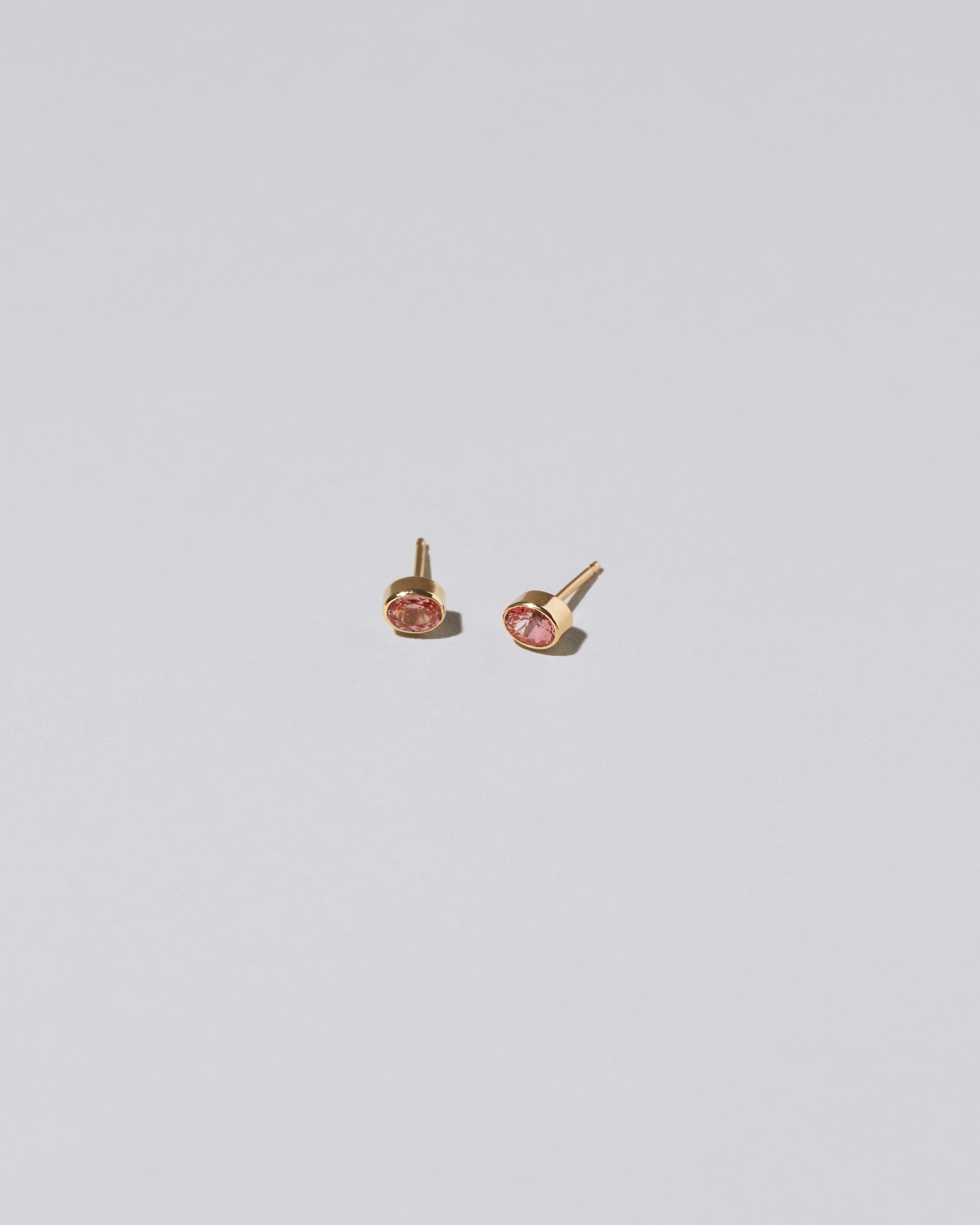 Oval Frame Stud Earrings on light color background.