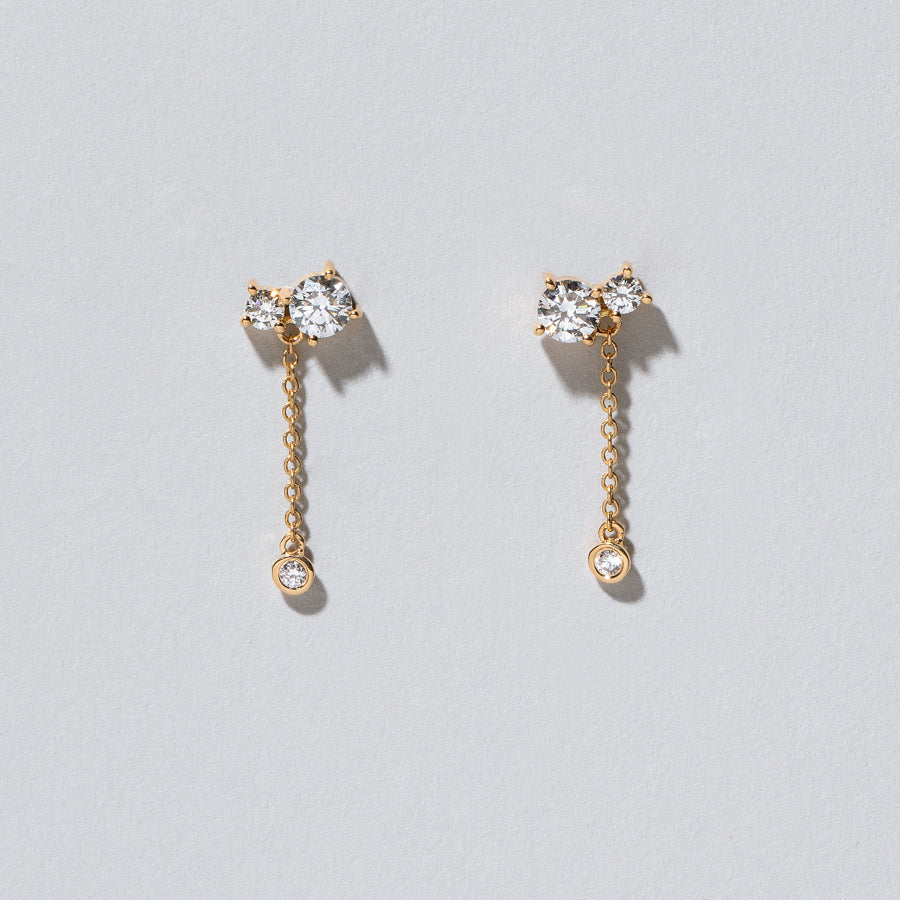 product_details::Closeup details of the Drop Aster Earrings on light color background.