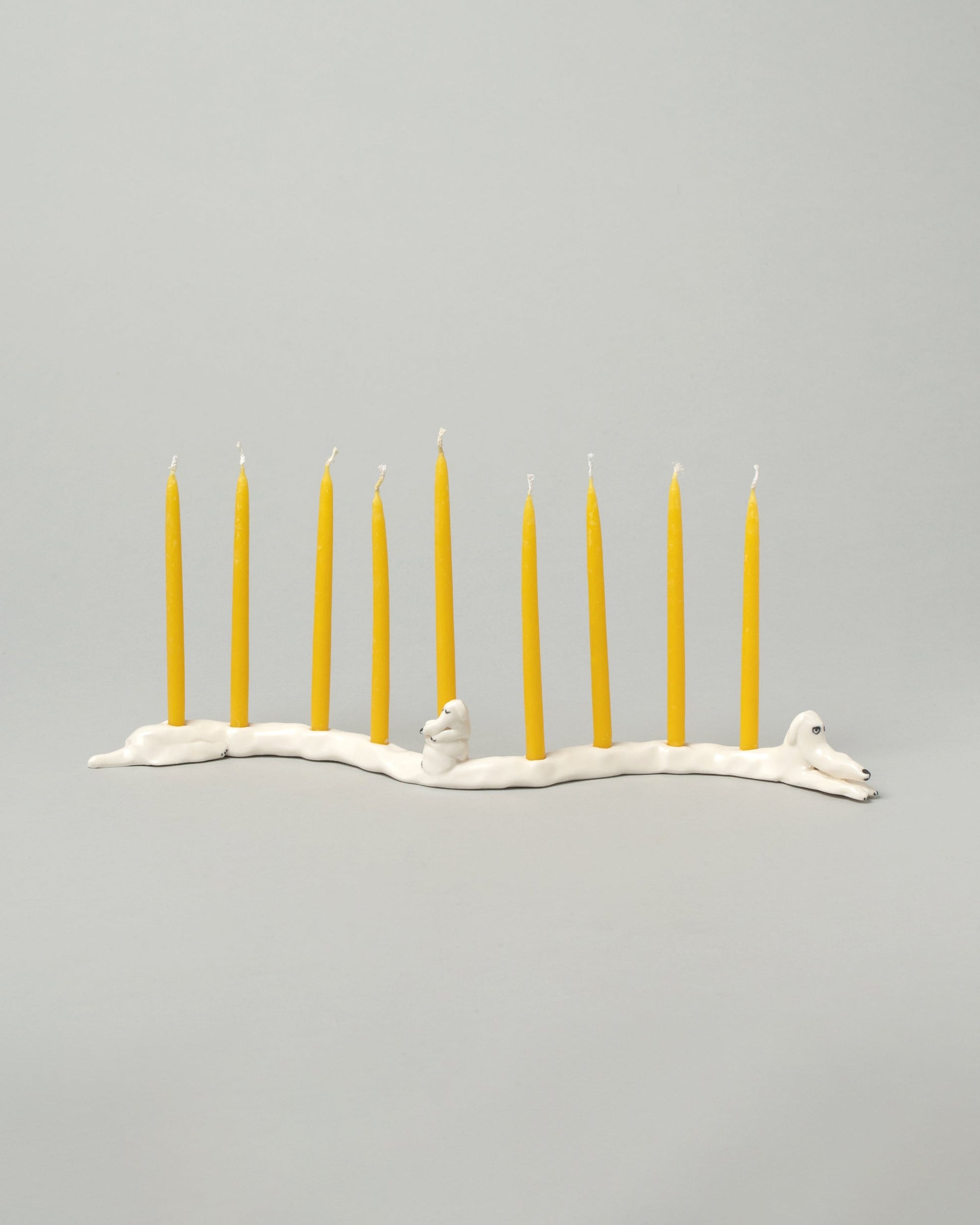 Detail view of the Eleonor Boström White Ears Dog Menorah on light color background.