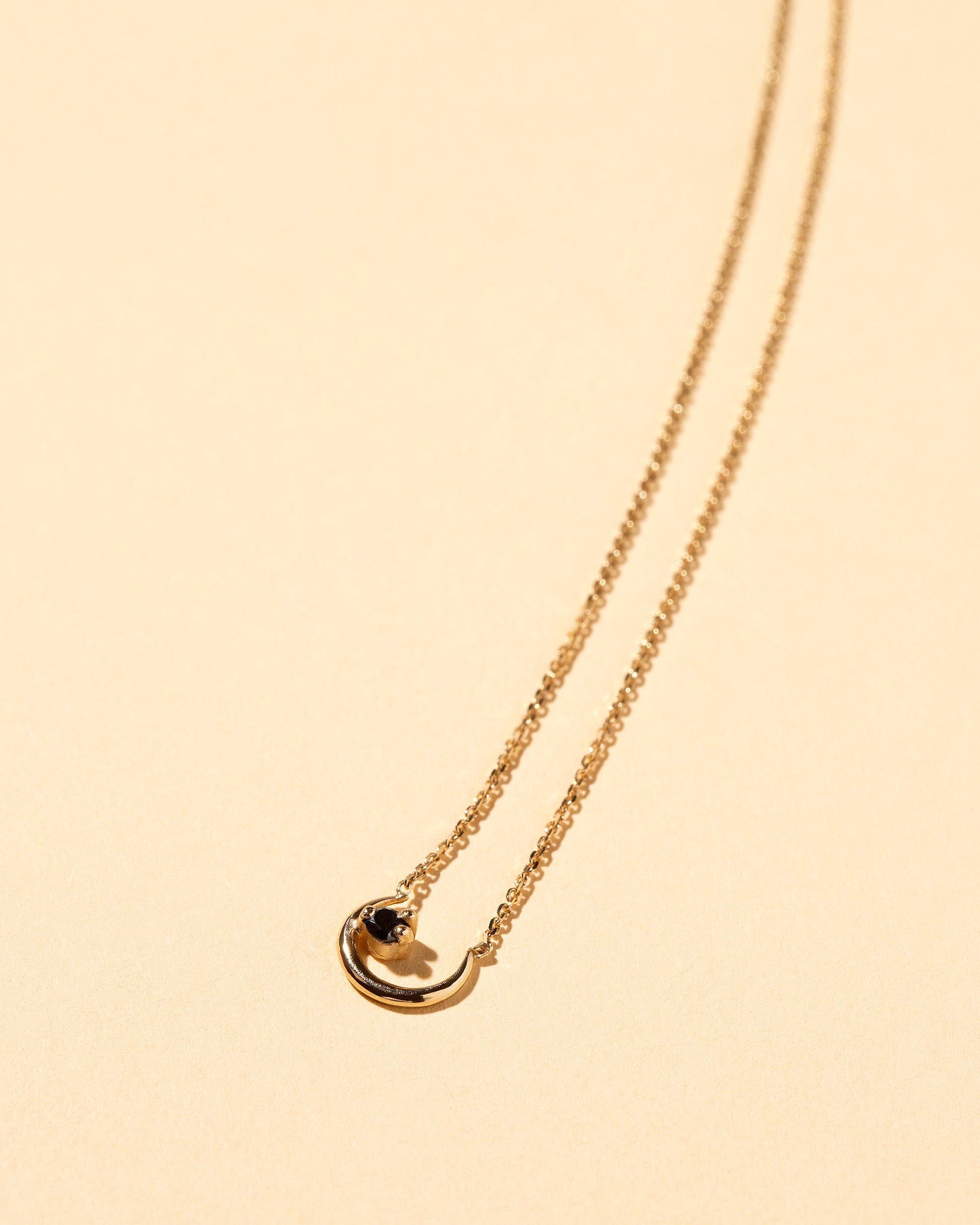 Moon Ray Necklace on light color background.