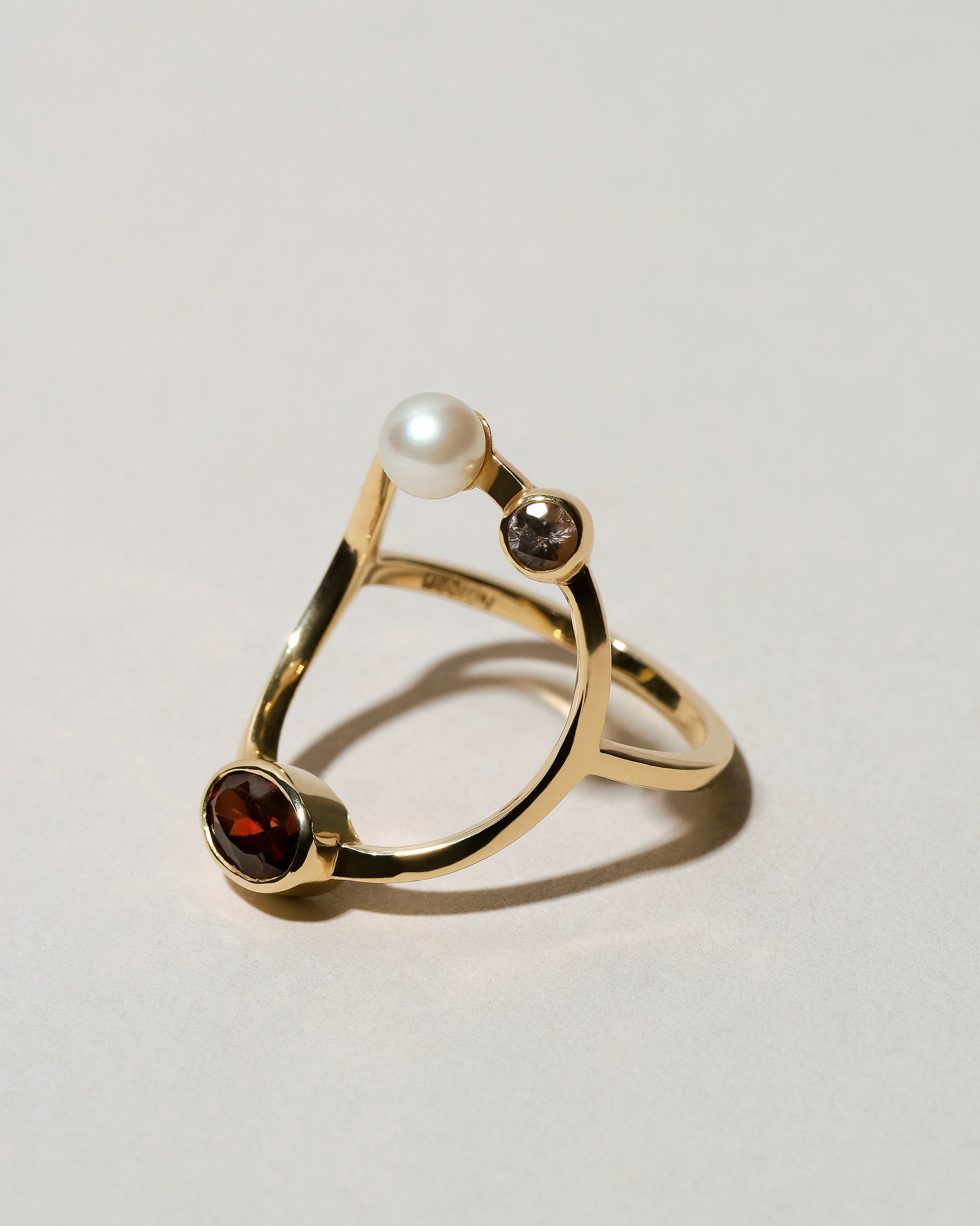 Trilogy Ring - Garnet on light color background.