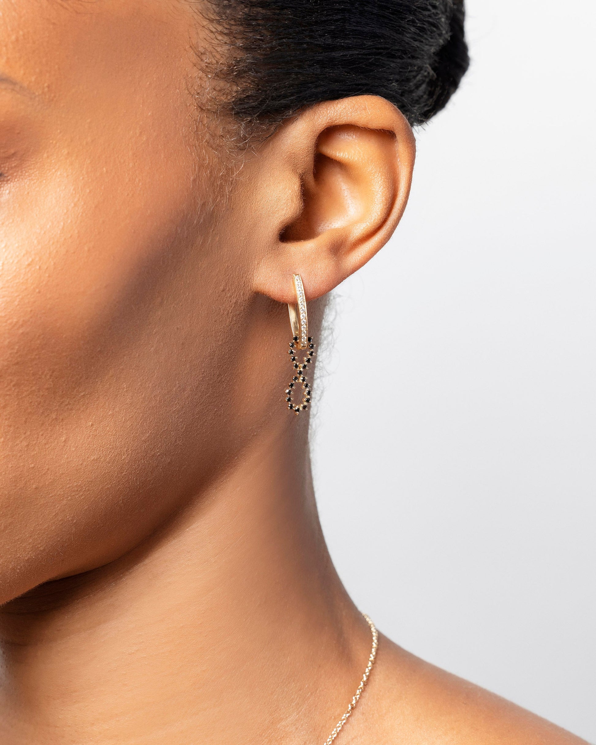 White Diamond and Black Diamond Lifecycle Earrings on model.