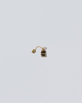 Tea Bag Charm on light color background.