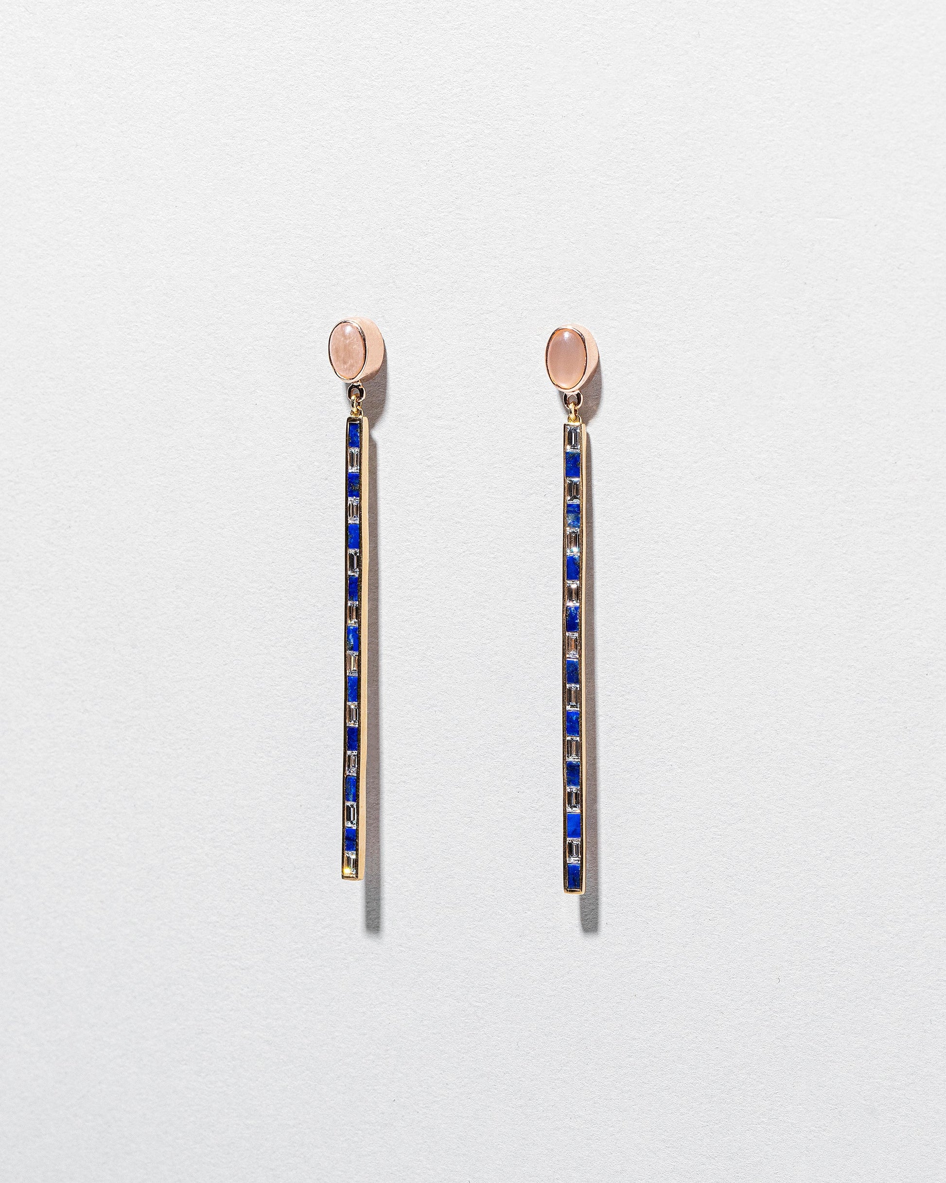 Peach Moonstone Transformation Earrings on light color background.