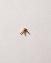 Gold Citrine Sun Ray Stud Earring Single on light color background.