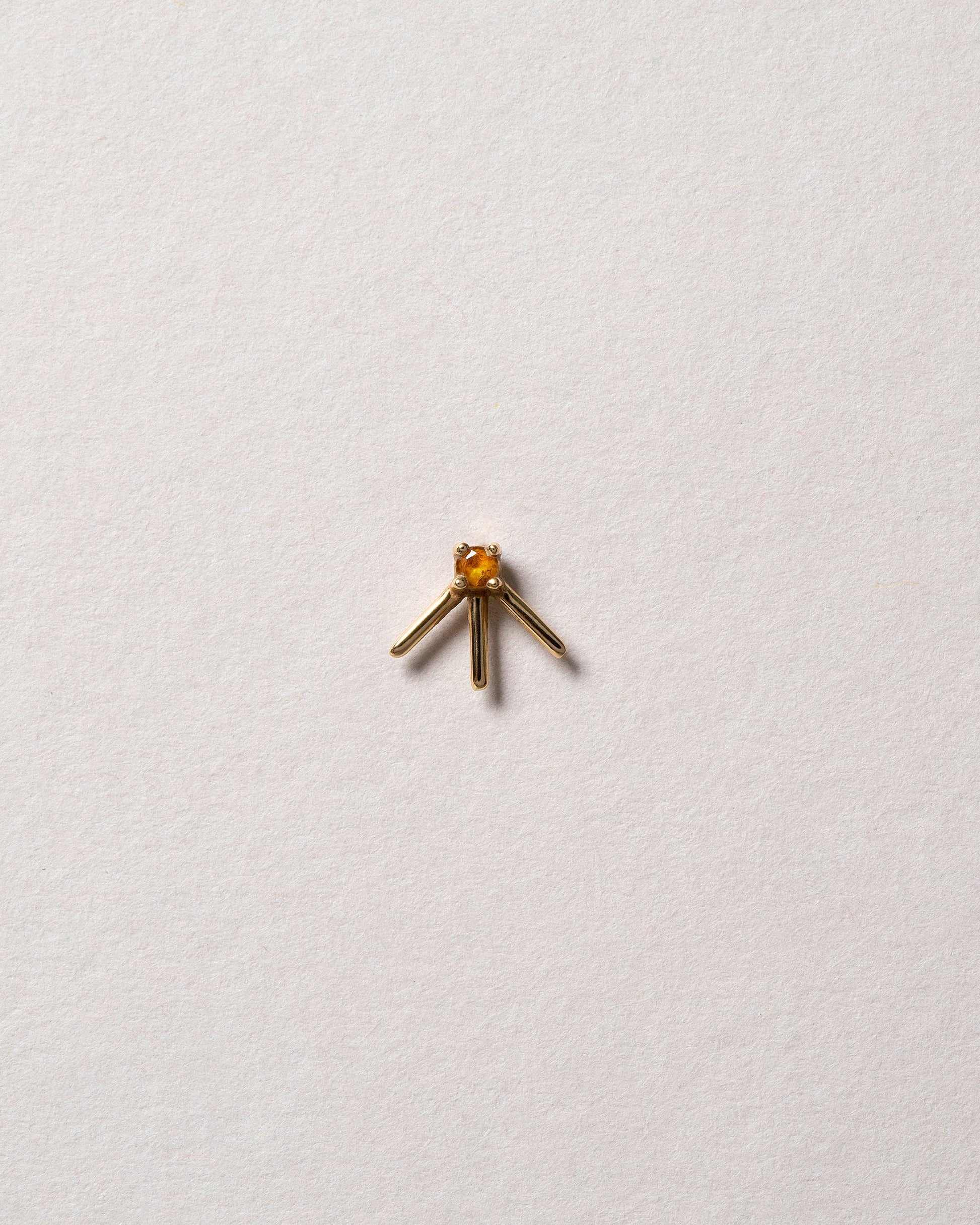 Gold Citrine Sun Ray Stud Earring Single on light color background.