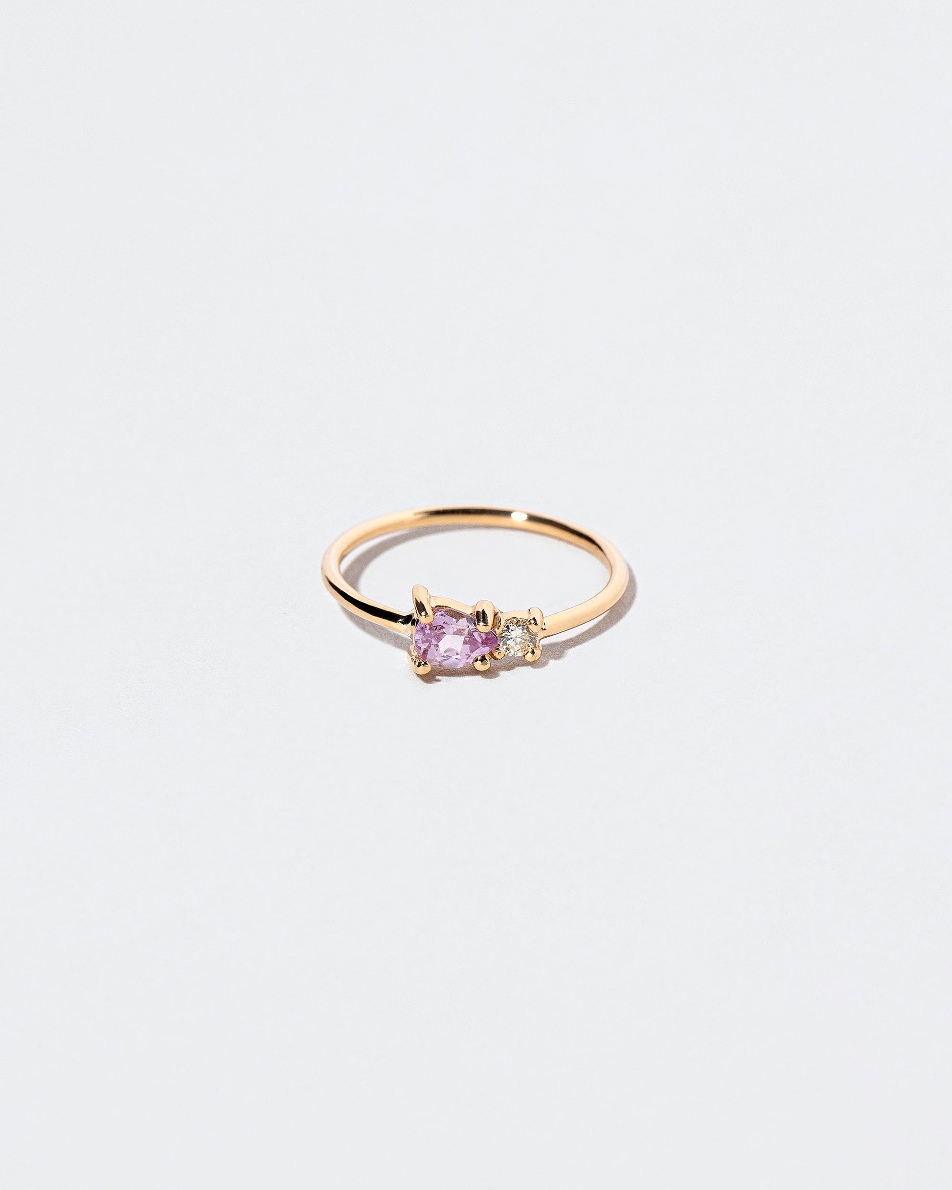 Pink Sapphire Teardrop Ring on light color background.