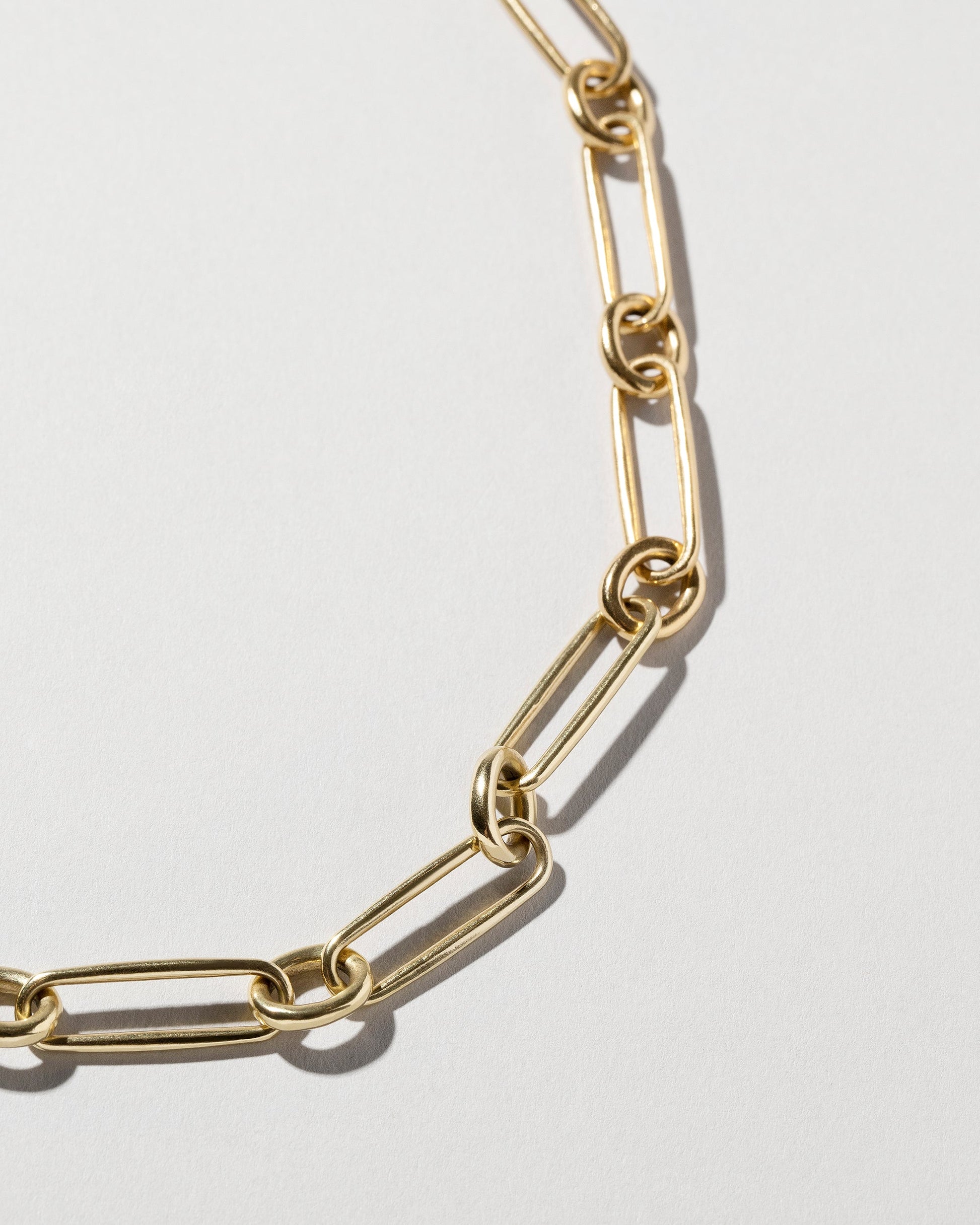 Closeup details of the Pavé Link Necklace on light color background.