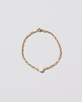 One Pearl Station Bracelet Hot Dog Chain on light color background.