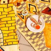 product_details::Styled image featuring the Avocado Charm, Carrot Charm, Shrimp Cocktail Charm, Red Radish Charm, Asparagus Charm and Clam on Half Shell Charm.