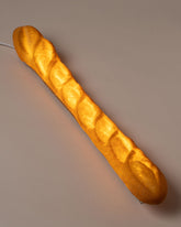 In-use detail view of the Pampshade Baguette Lamp on light color background.
