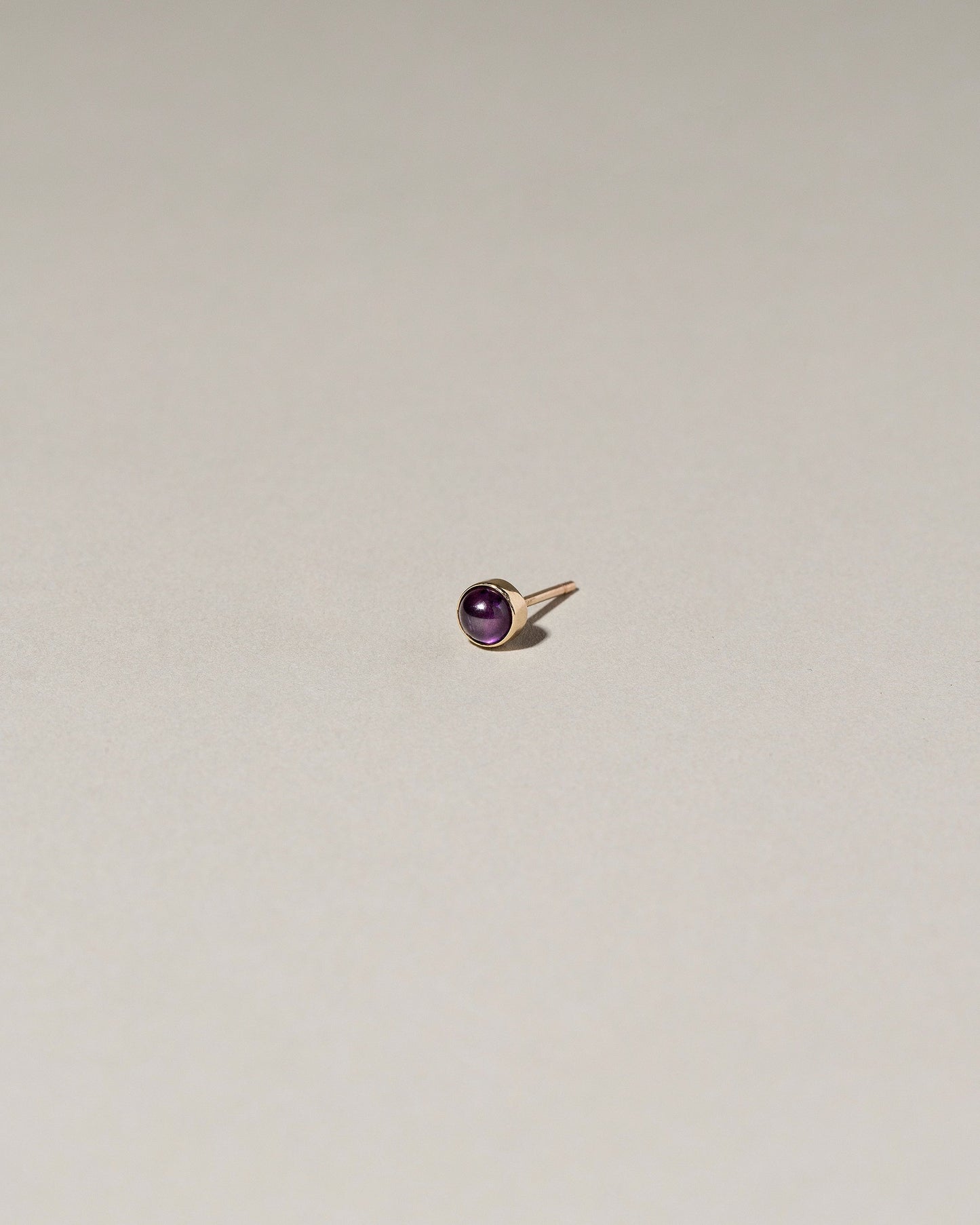  Birthstone Single Stud on light color background.