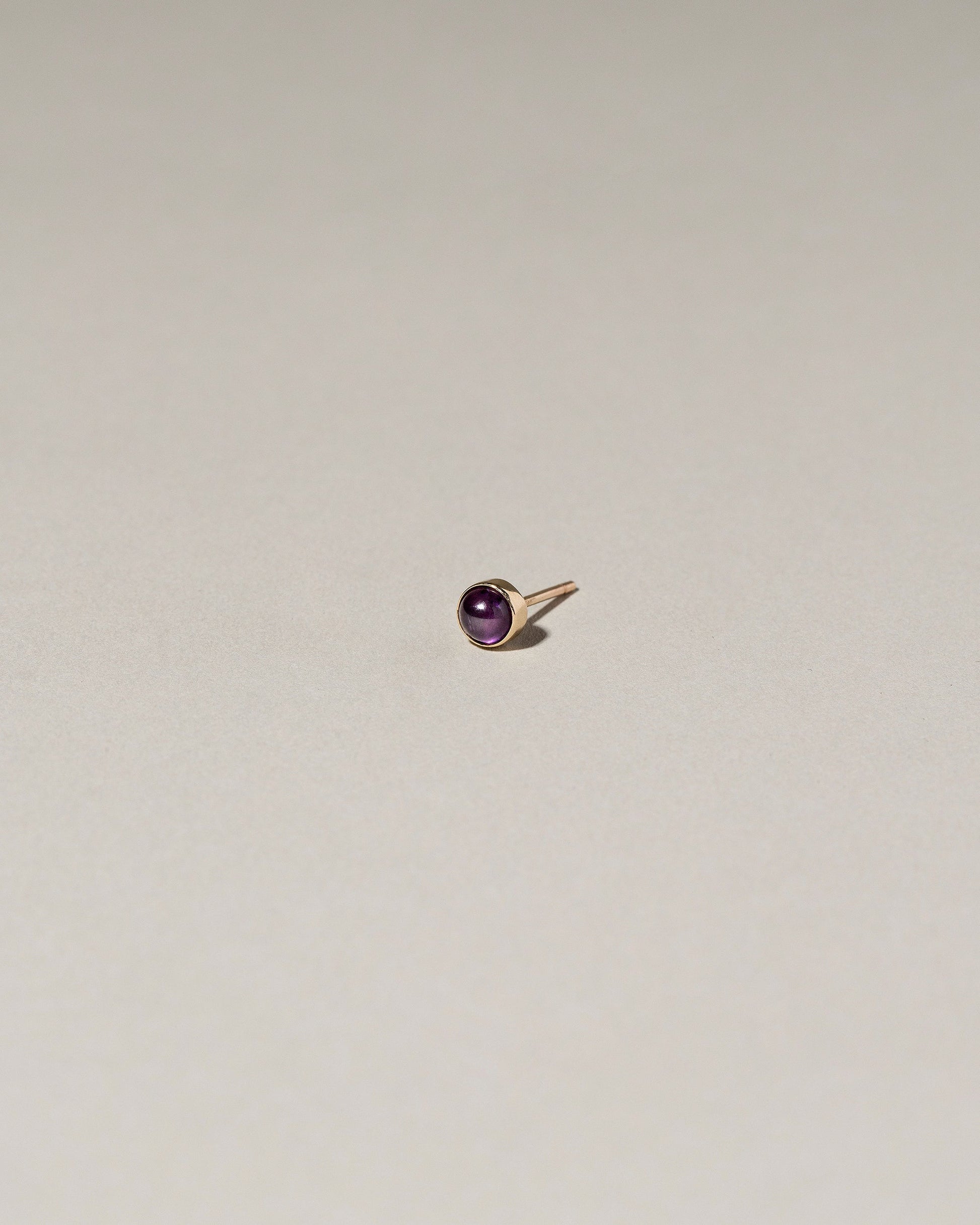 Birthstone Single Stud on light color background.