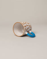 Detail view of Recreation Center Blue Mark Mug on light color background.