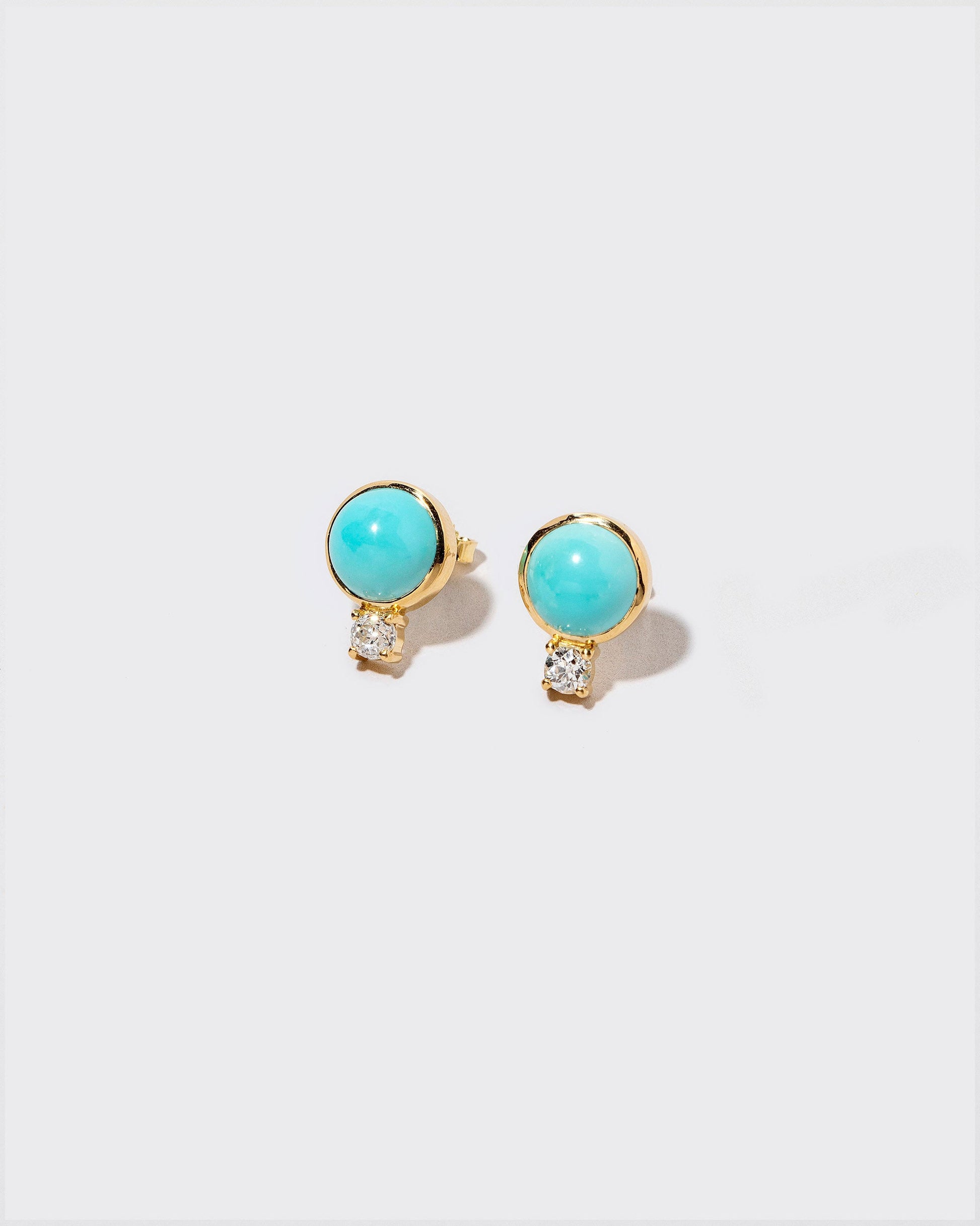 In-Between Earrings on light color background.