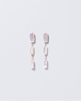 Pelias Earrings on light color background.