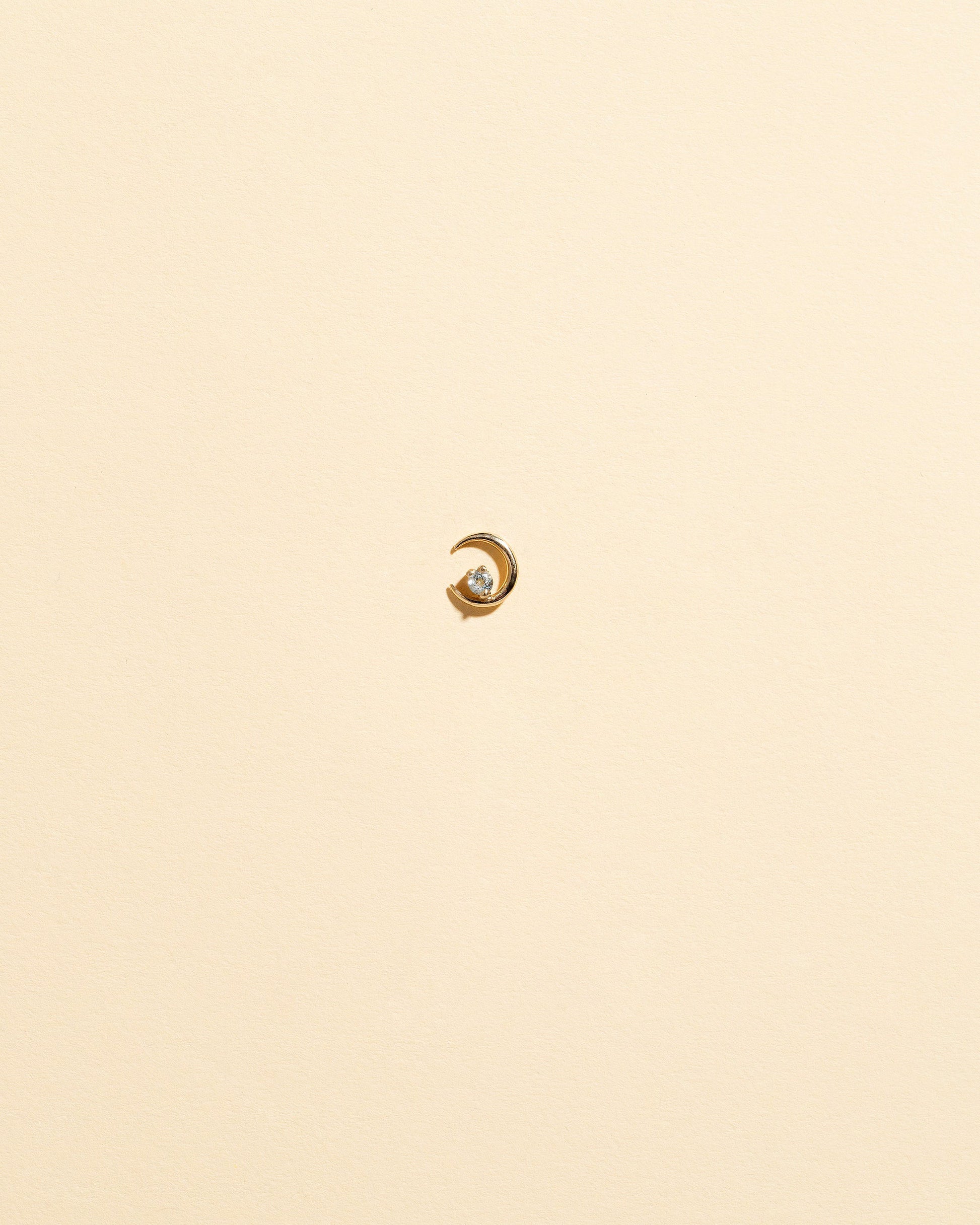 Left White Diamond Moon Ray Stud Earring Single on light color background.