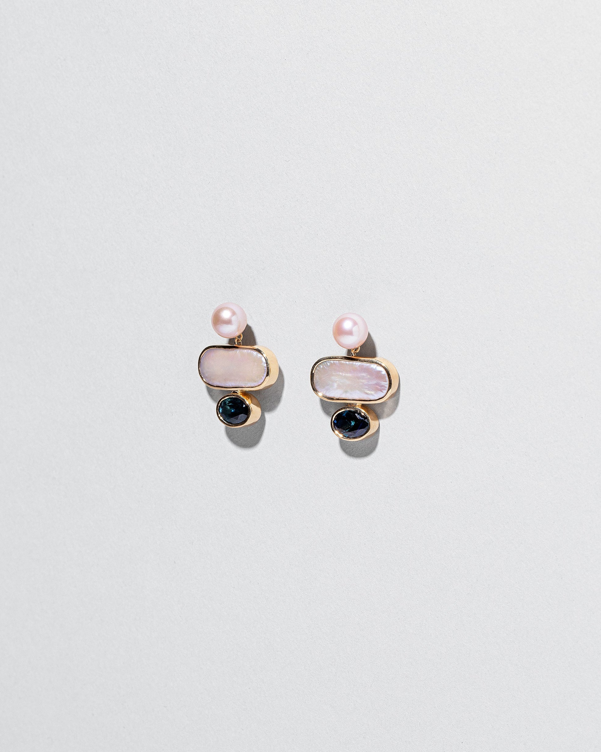 Mantle Earrings on light color background.