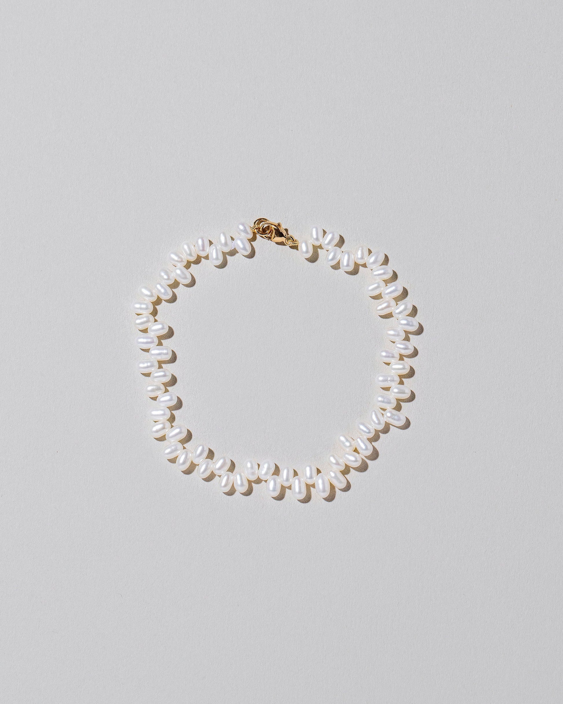 Zipper Pearl Bracelet on light color background.