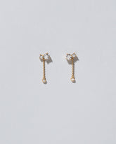 Drop Aster Earrings on light color background.