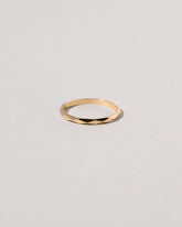 Gold 2mm Facet Band on light color background.