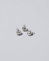 Silver garlic charm on light colored background