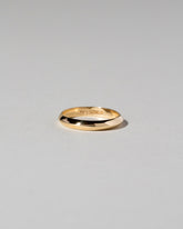 Gold 2.5mm Knife Edge Band on light color background.