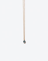 Product photo of gemstone necklace on a light color background