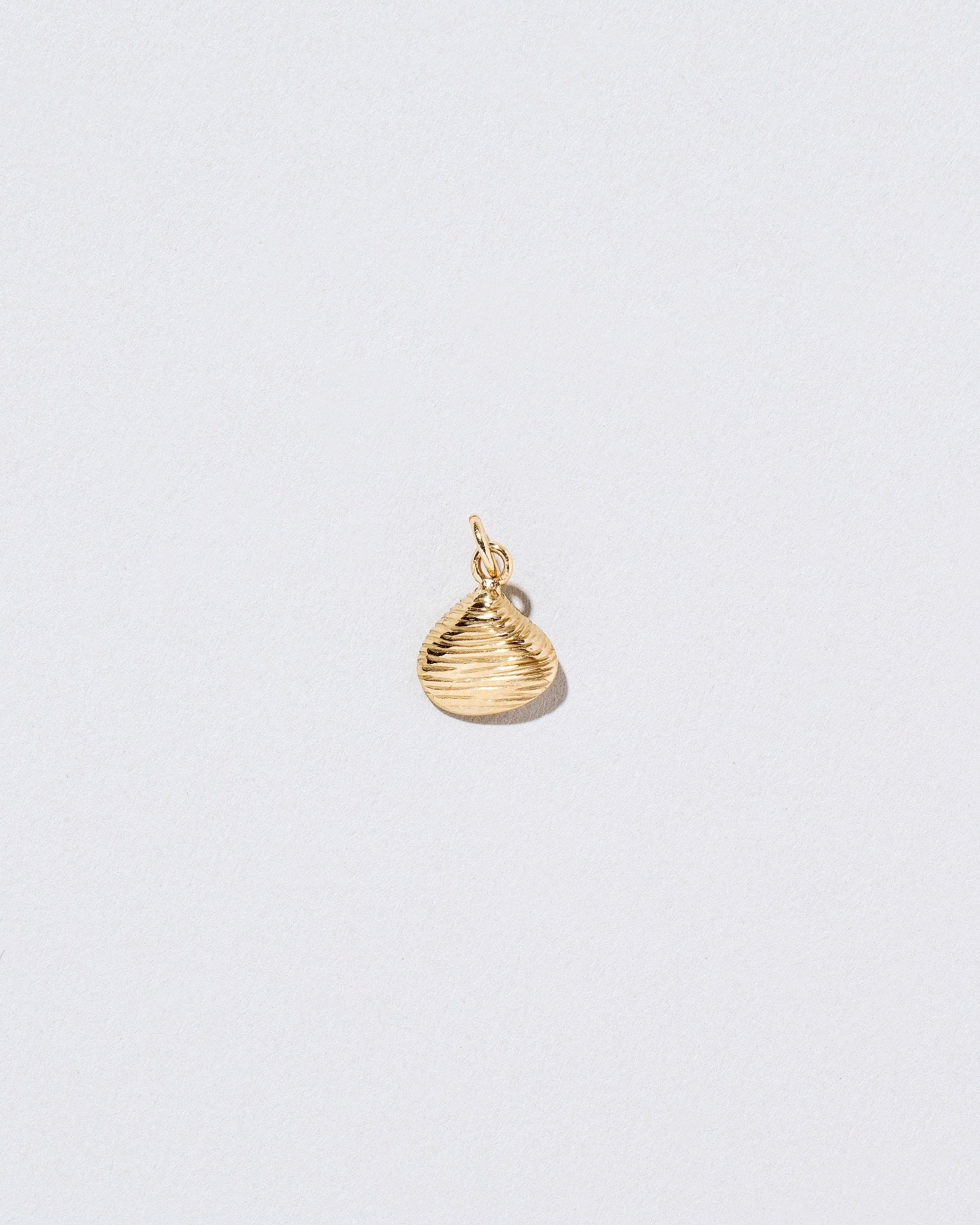 Clams Casino Charm on light color background.