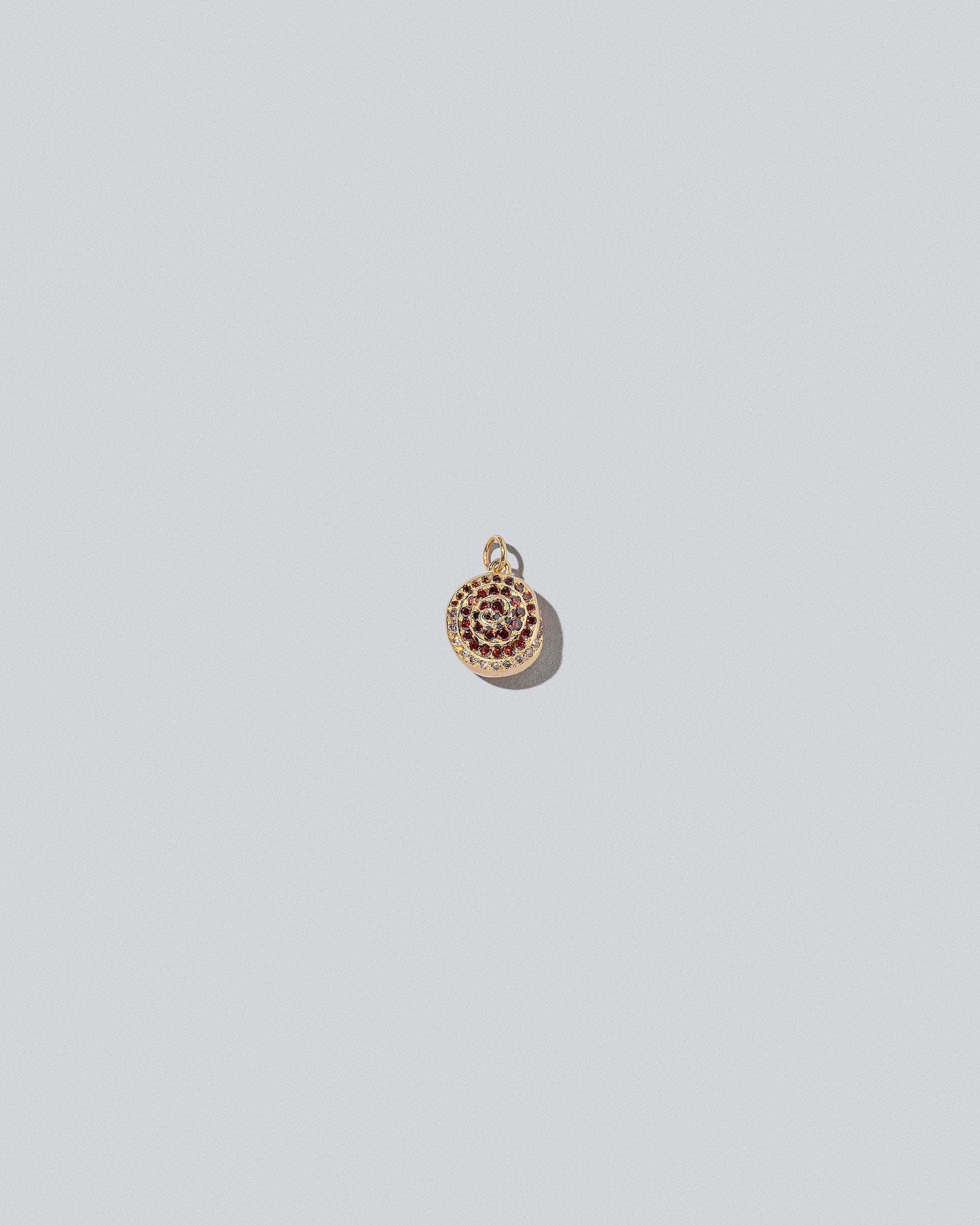 Cinnamon Roll Charm - Pavés on light color background.