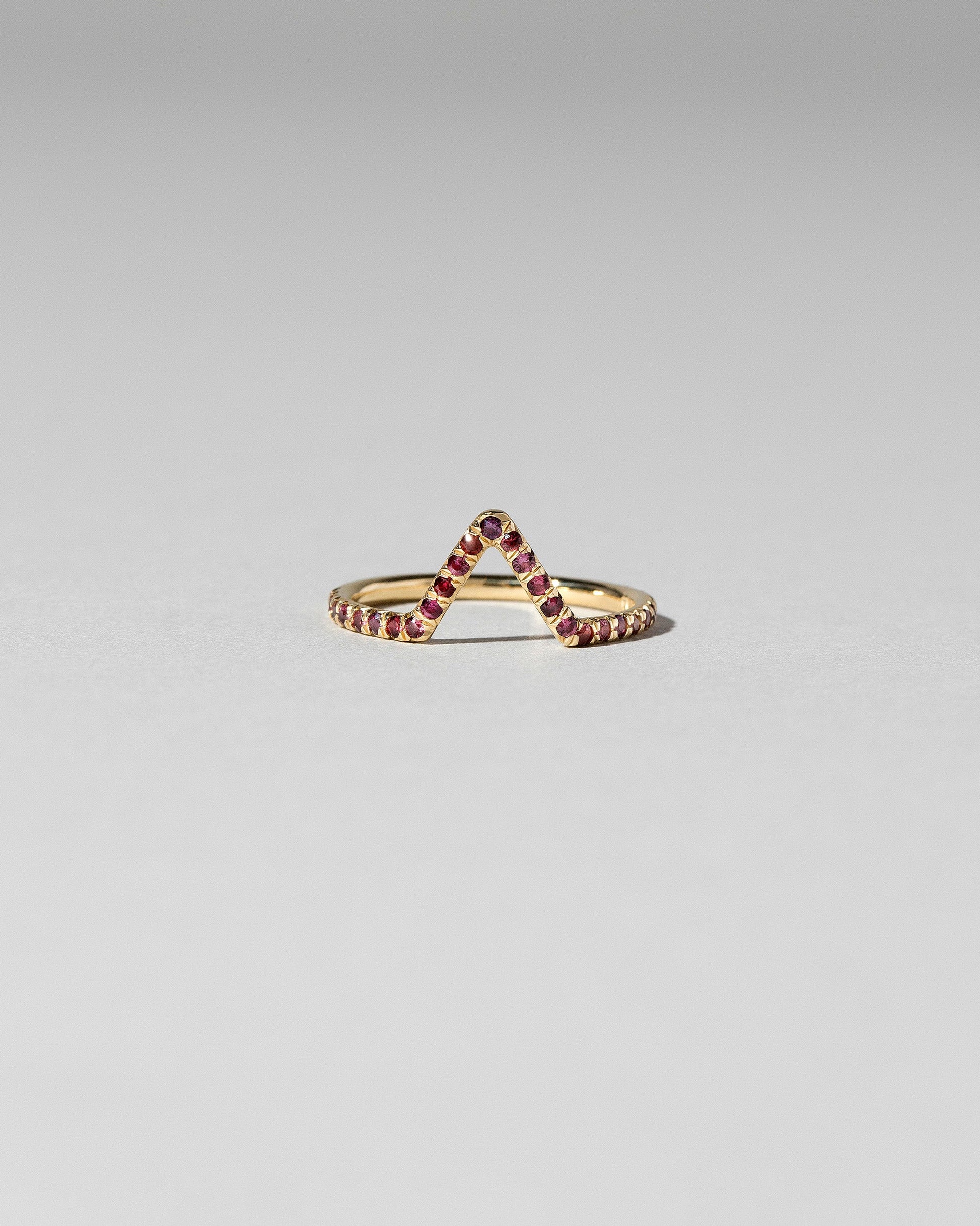 Red Anthill Garnet Pavé Triangle Band on light color background.