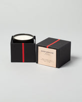 Good Medicine Santalum Candle on light color background.