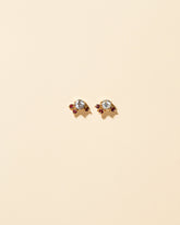 Aquamarine & Garnet Earrings on light color background.